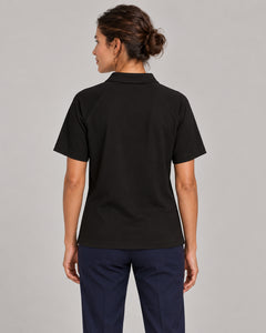 Woman wearing Putting dachshund golf polo, back studio view. Color: Black