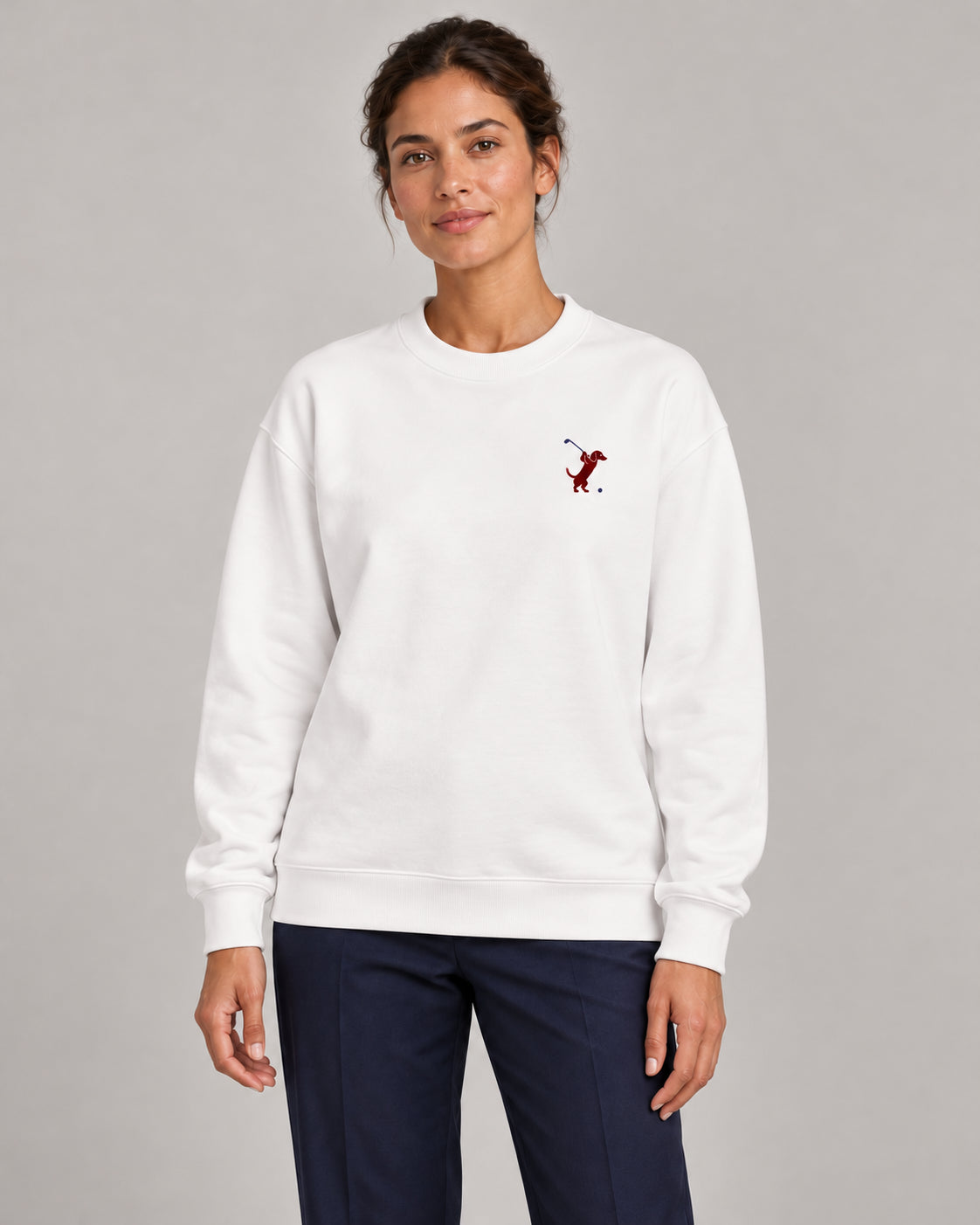 Woman wearing Swing dachshund golf sweatshirt, front studio view. Color: White