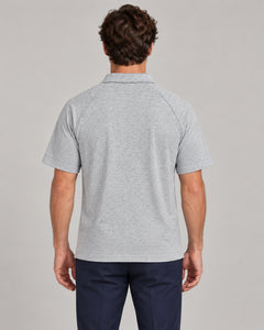 Man wearing Putting dachshund golf polo, back studio view. Color: Flower Gray