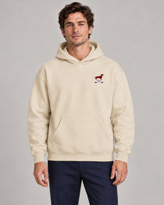 Man wearing Club & Swing dachshund golf hoodie, front studio view. Color: Apricot