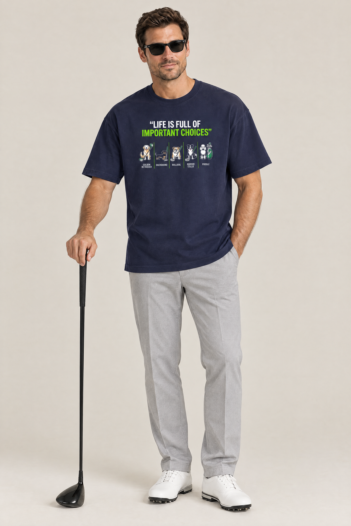 Man wearing the Full of Choices Dog Golf Tee in navy with grey trousers and a driver. Color: Navy