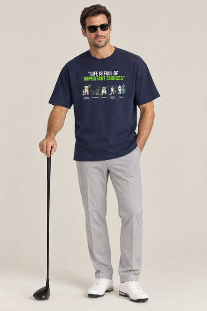 Man wearing the Full of Choices Dog Golf Tee in navy with grey trousers and a driver. Color: Navy