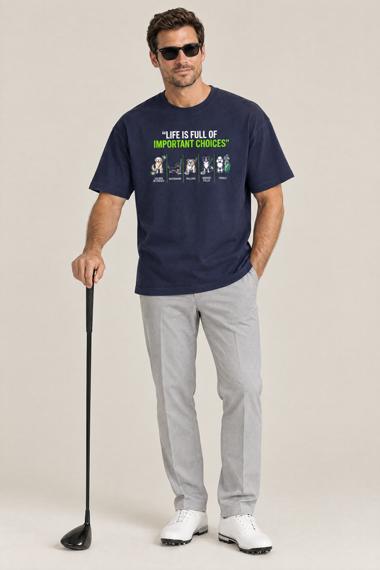 Man wearing the Full of Choices Dog Golf Tee in navy with grey trousers and a driver. Color: Navy