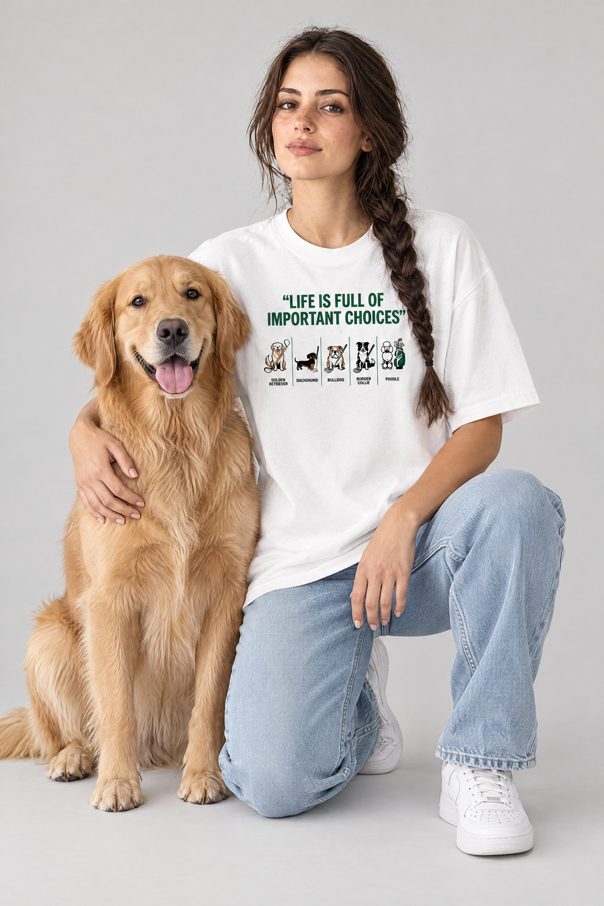 Woman kneeling with a golden retriever in the white Full of Choices Dog Golf Tee. Color: White