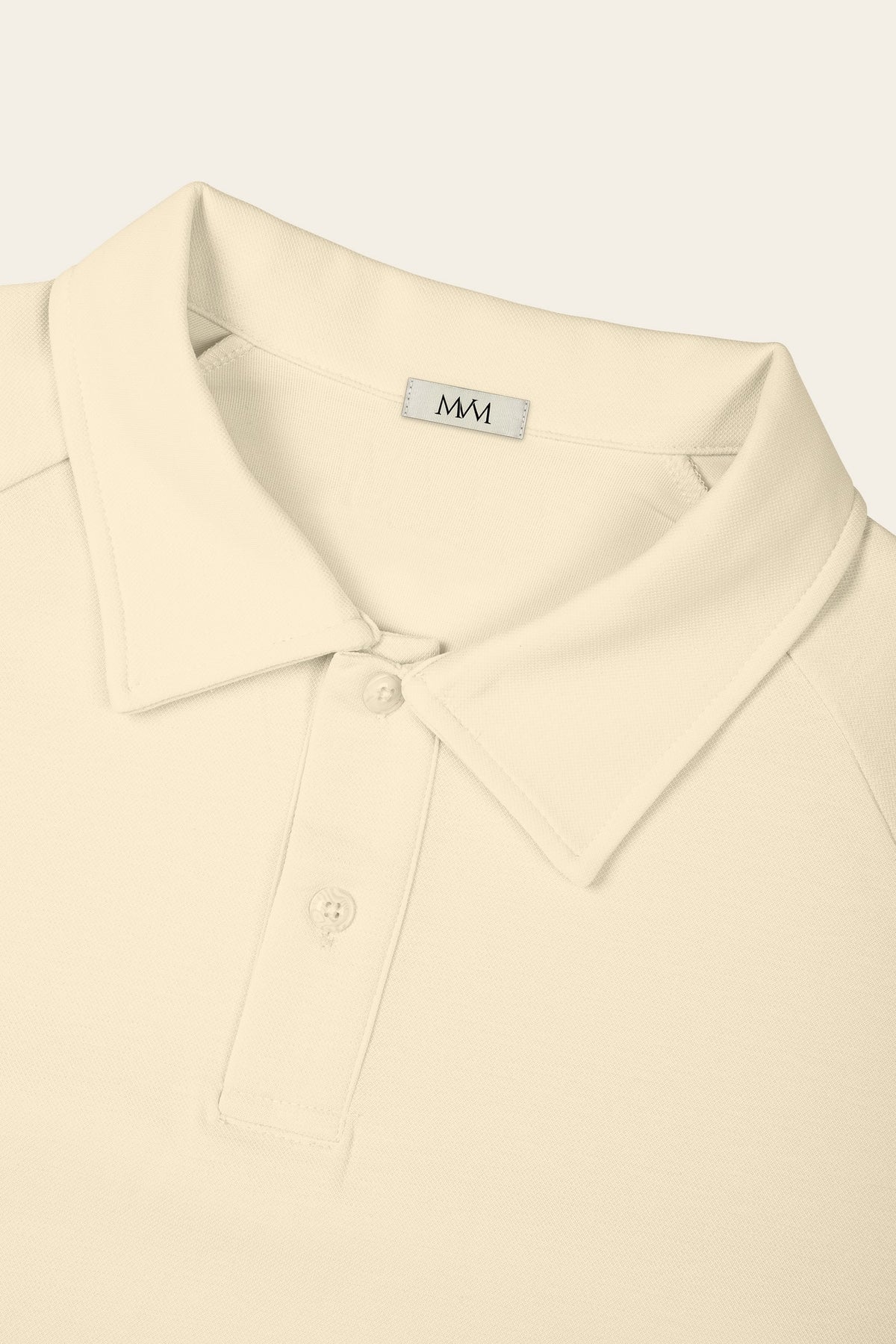 Close-up of the collar and two-button placket of the apricot golf polo with the MVM woven neck label. Color: Apricot