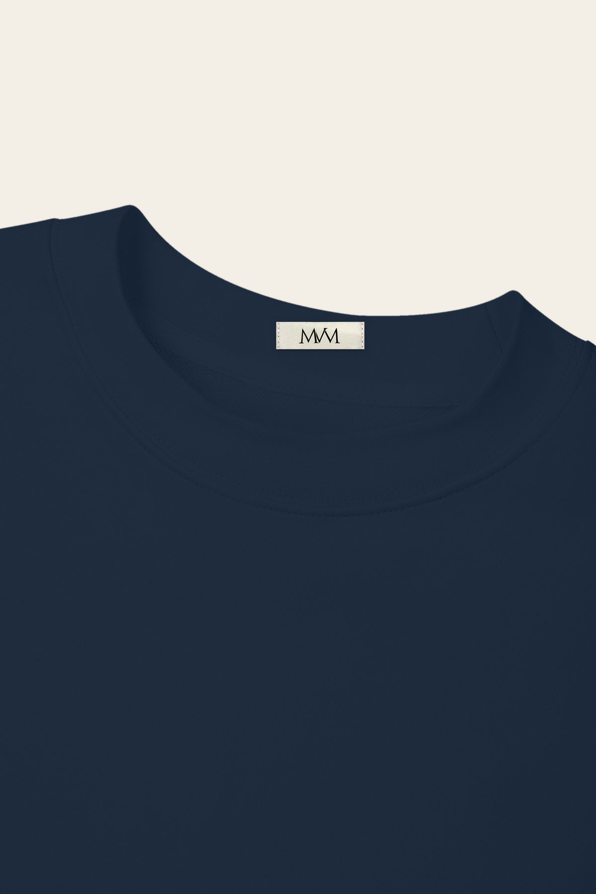 Close-up of the ribbed crew neck of the navy golf sweatshirt with the MVM woven neck label. Color: Navy
