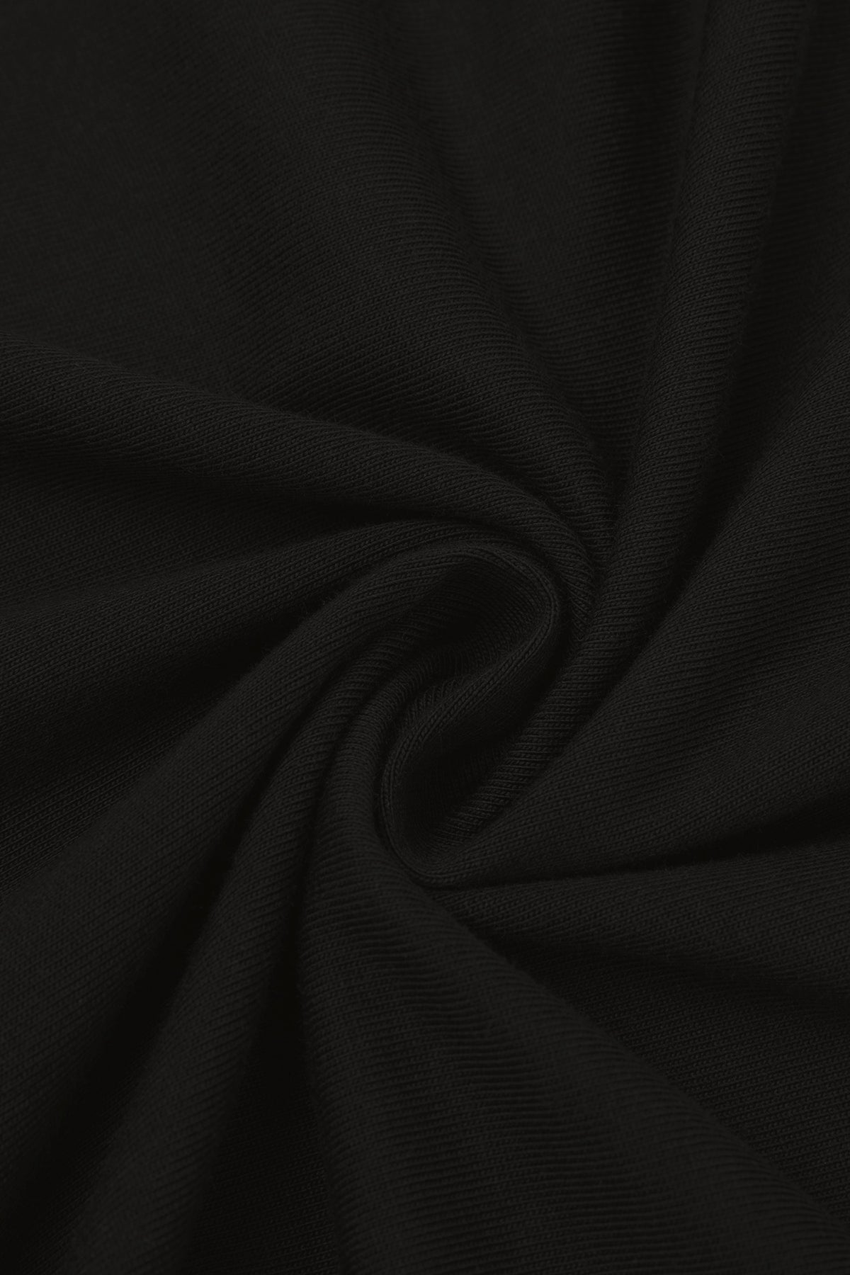 Close-up of the soft cotton fabric of the black golf t-shirt. Color: Black