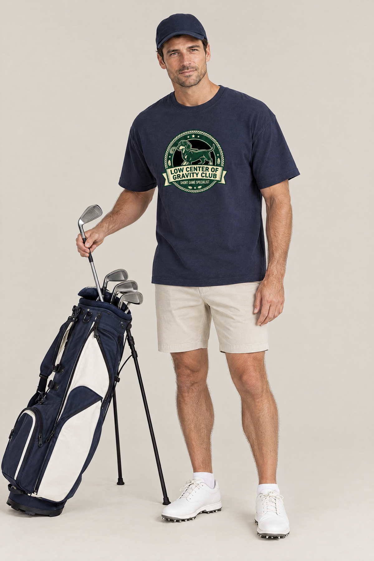 Man pulling an iron from a golf bag in the navy Low Center of Gravity Club Dachshund Golf Tee. Color: Navy