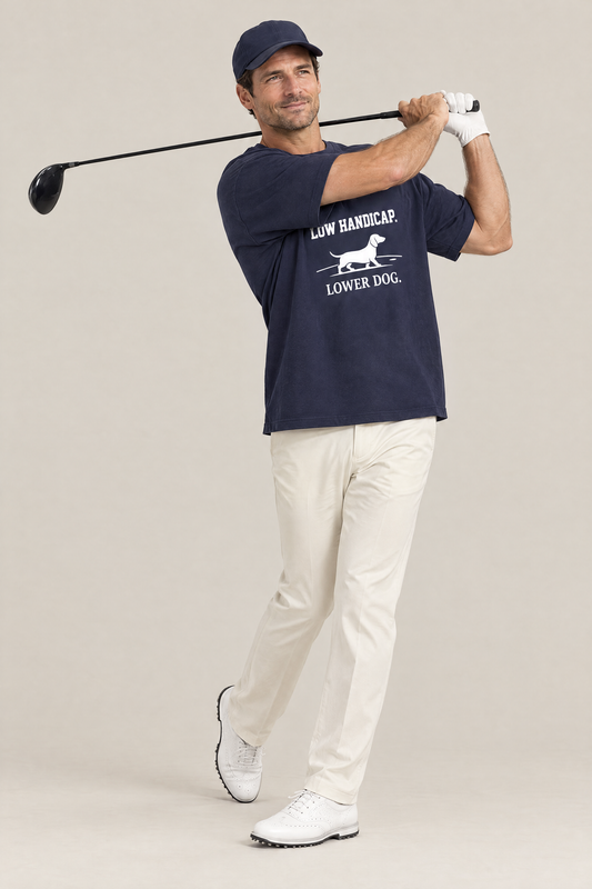 Man finishing a golf swing in the navy Low Handicap Dachshund Golf Tee. Color: Navy