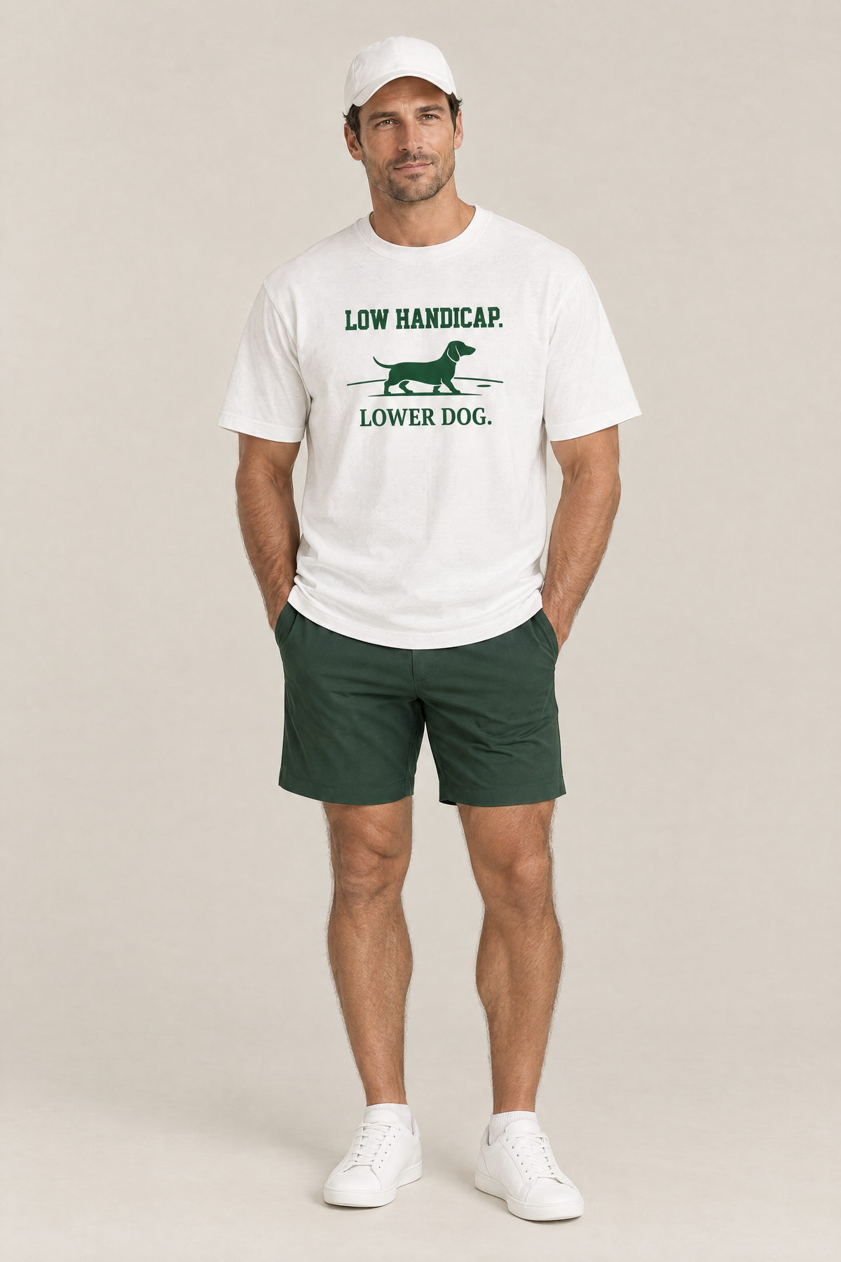 Man wearing the Low Handicap Dachshund Golf Tee in white with green golf shorts and a white cap. Color: White