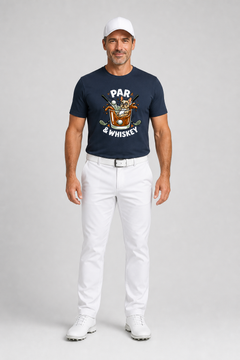 Man wearing a navy t-shirt with a graphic design and white pants on a gray background