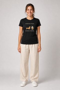 Person wearing a black t-shirt with a graphic design on a plain background