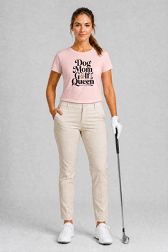 Woman wearing a pink t-shirt with 'Dog Mom Golf Queen' text, holding a golf club on a gray background
