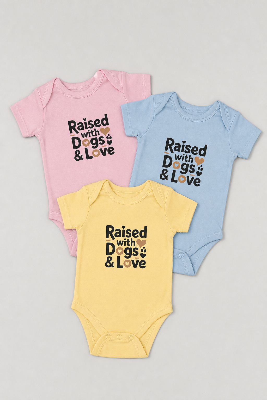 Baby wearing pink Raised With Dogs and Love bodysuit