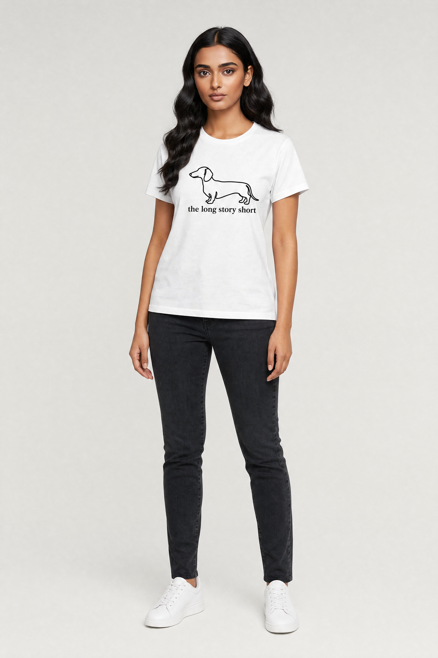 Woman wearing a white t-shirt with a graphic design on a plain background