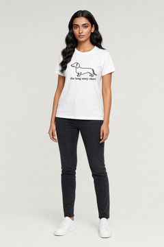Woman wearing a white t-shirt with a graphic design on a plain background
