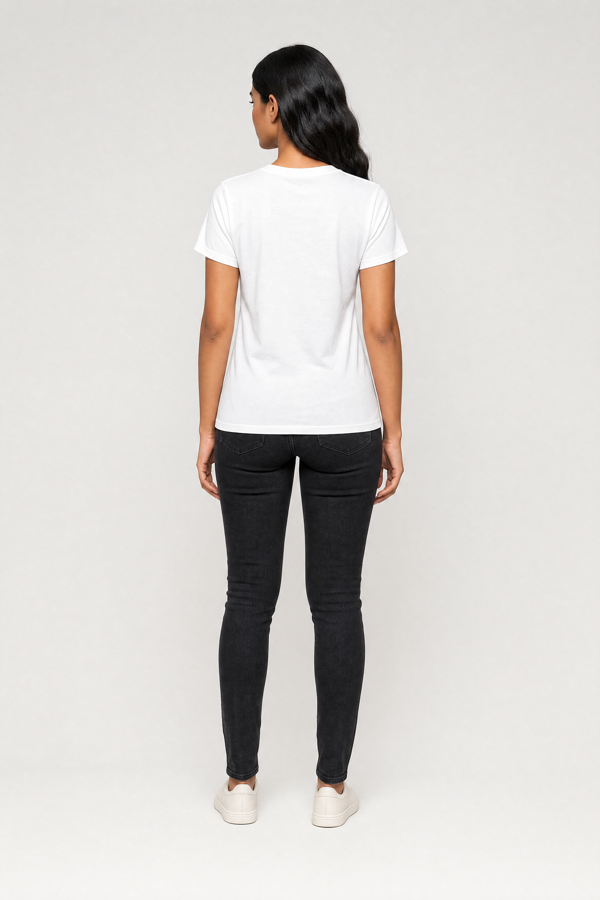 Person wearing a white t-shirt and black pants on a white background
