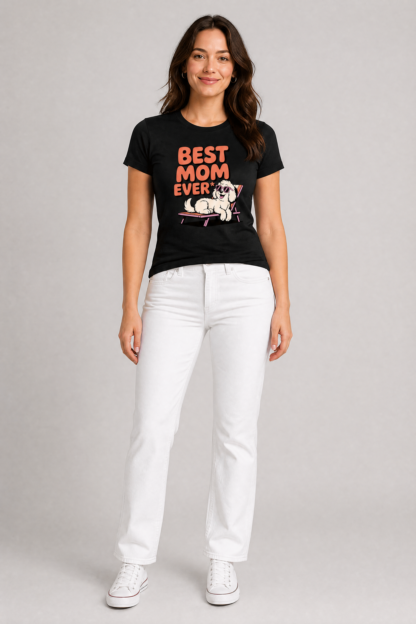Woman wearing a black t-shirt with 'Best Mom Ever' text and white pants on a gray background