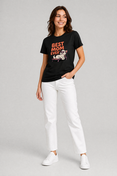 Woman wearing a black t-shirt with 'Best Mom Ever' and a dog graphic, standing against a gray background.