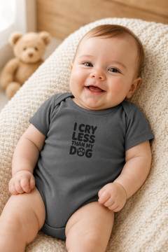 White baby bodysuit with I Cry Less Than My Dog print, snap closure