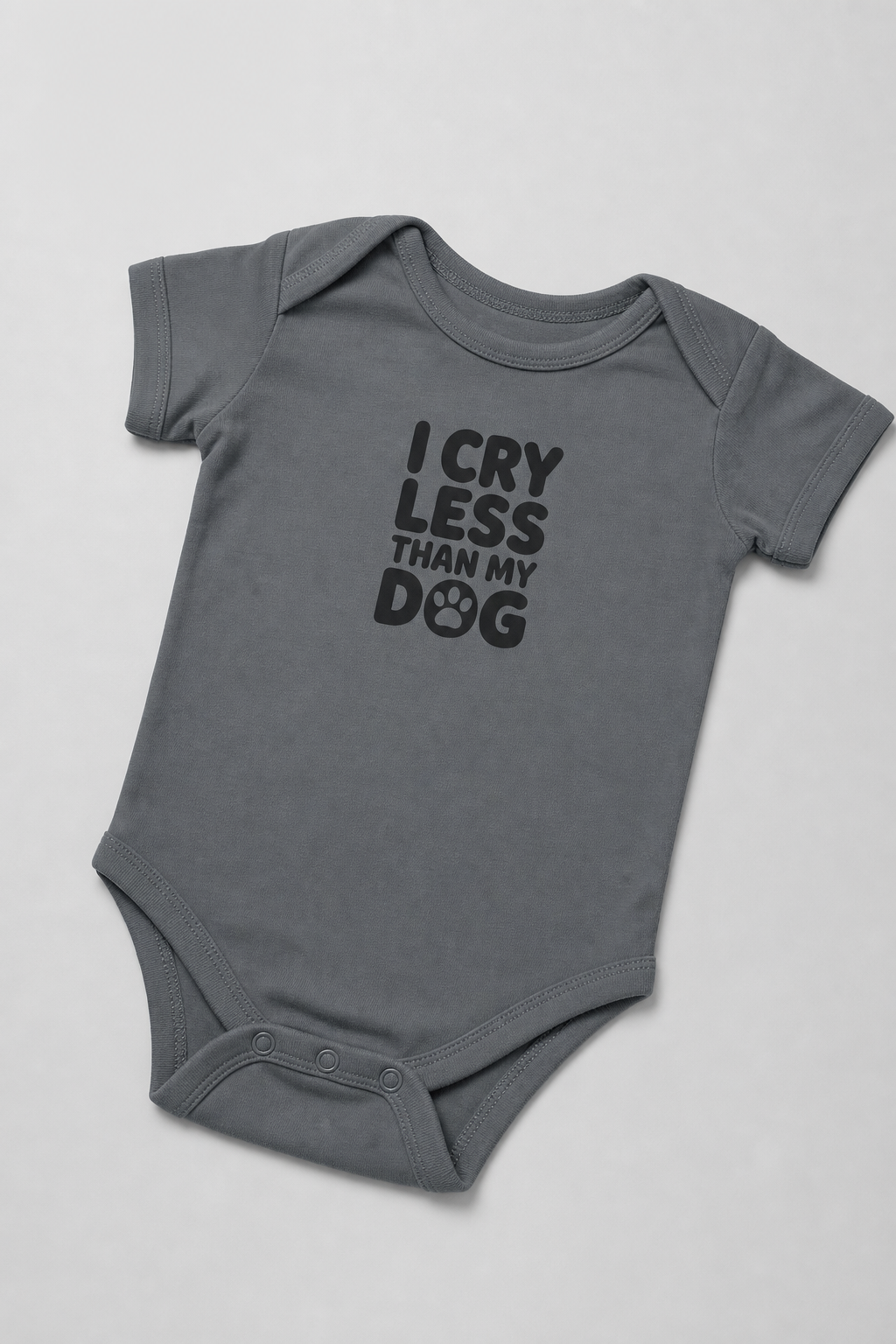 Baby wearing white I Cry Less Than My Dog bodysuit, snap closure