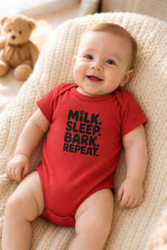 White baby bodysuit with Milk Sleep Bark Repeat dog print, snap closure