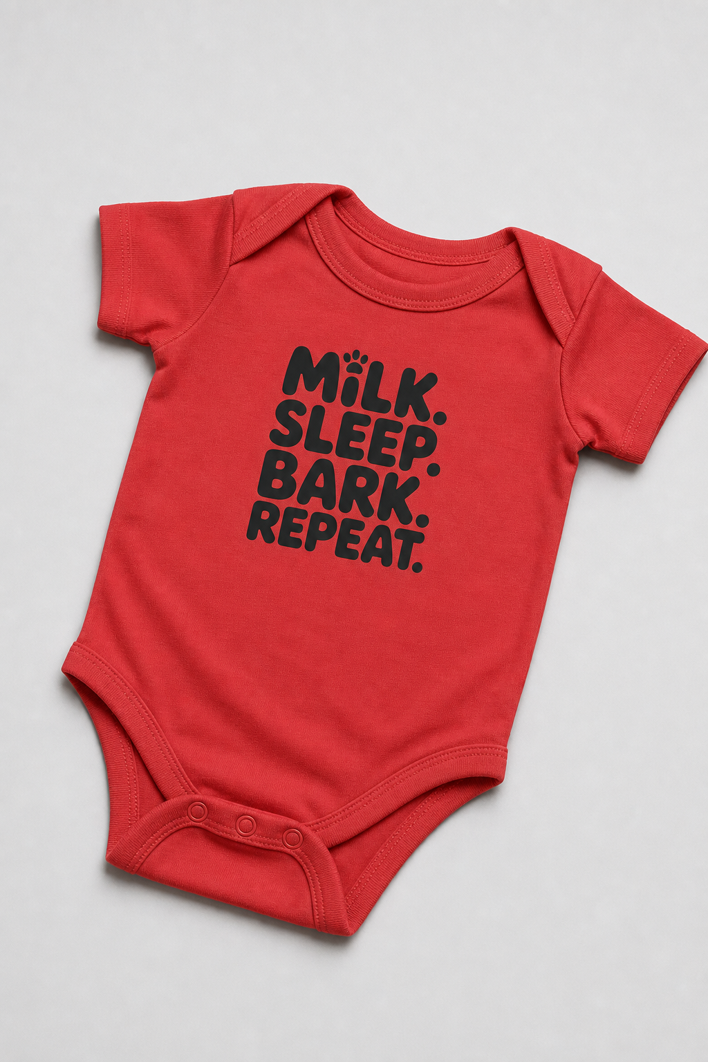 Baby wearing white Milk Sleep Bark Repeat bodysuit, snap closure