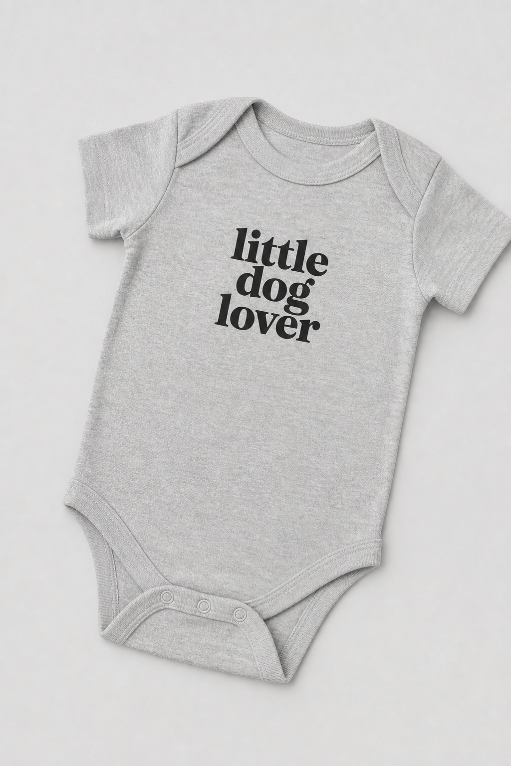 Baby wearing white Little Dog Lover bodysuit, snap closure