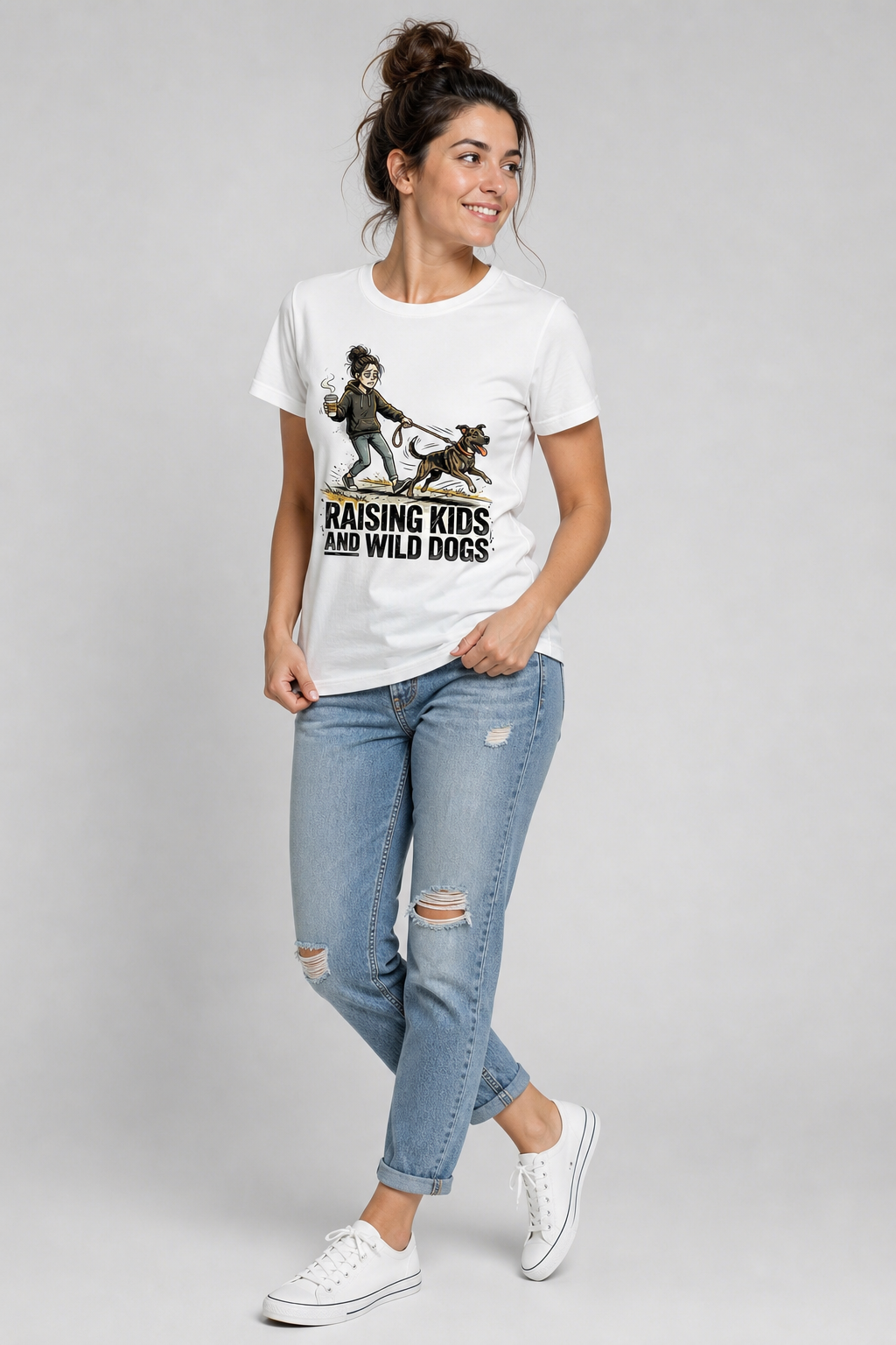 Woman wearing white Raising Kids and Wild Dogs t-shirt