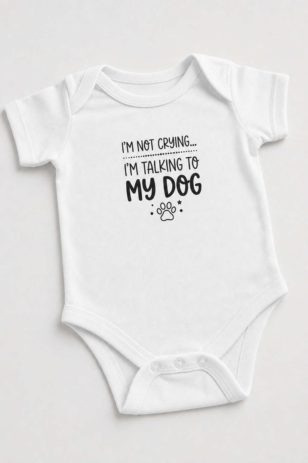 Baby wearing white I'm Talking to My Dog bodysuit, snap closure