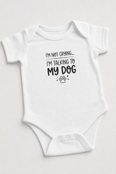 Baby wearing white I'm Talking to My Dog bodysuit, snap closure