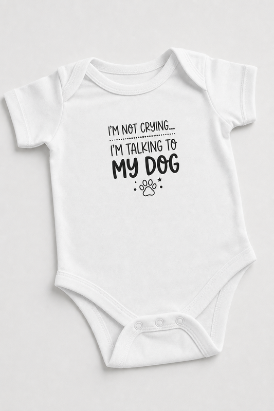Baby wearing white I'm Talking to My Dog bodysuit, snap closure