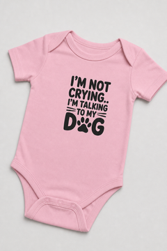 Baby wearing white I'm Talking to My Dog bodysuit, snap closure