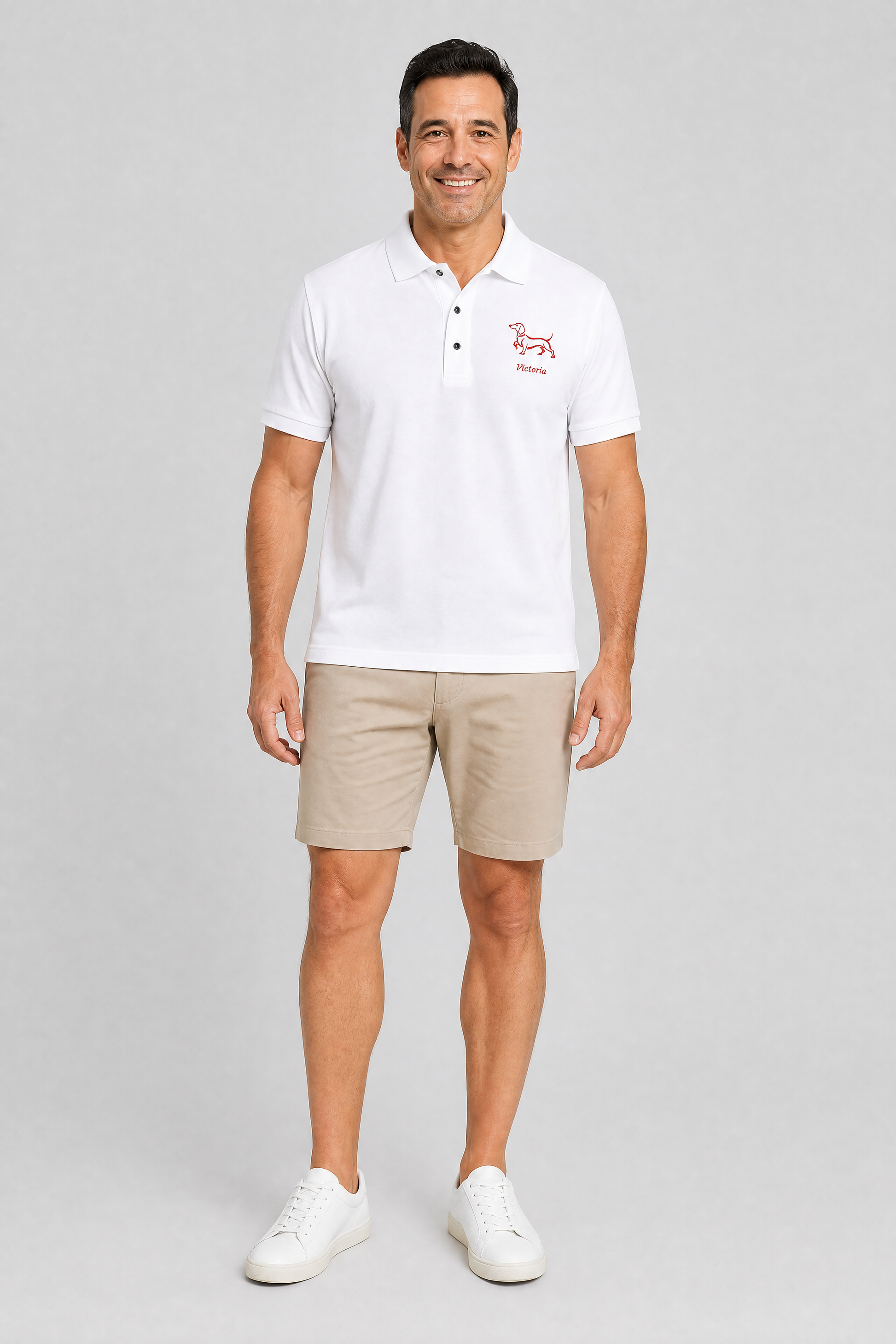 White embroidered dachshund polo shirt with personalized dog name, front flat lay