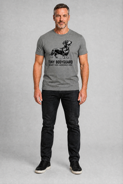 Man wearing a gray t-shirt with a graphic design on a plain background