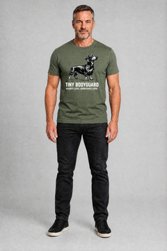 Man wearing a green t-shirt with a graphic and text, standing against a gray background