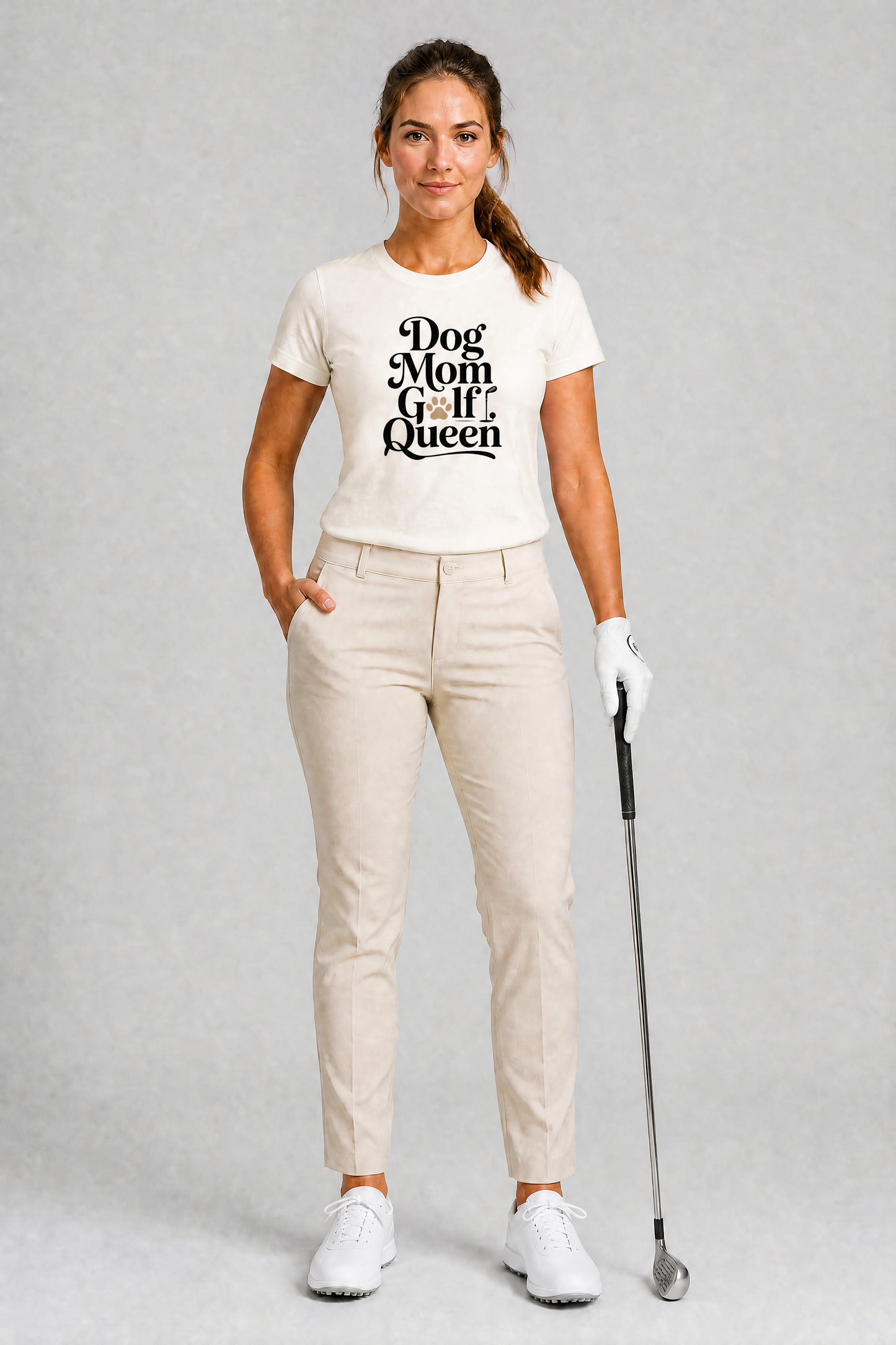 Woman in golf attire with a 'Dog Mom Golf Queen' t-shirt on a gray background