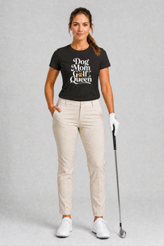 Woman wearing a navy t-shirt with 'Dog Mom Golf Queen' text, holding a golf club on a gray background