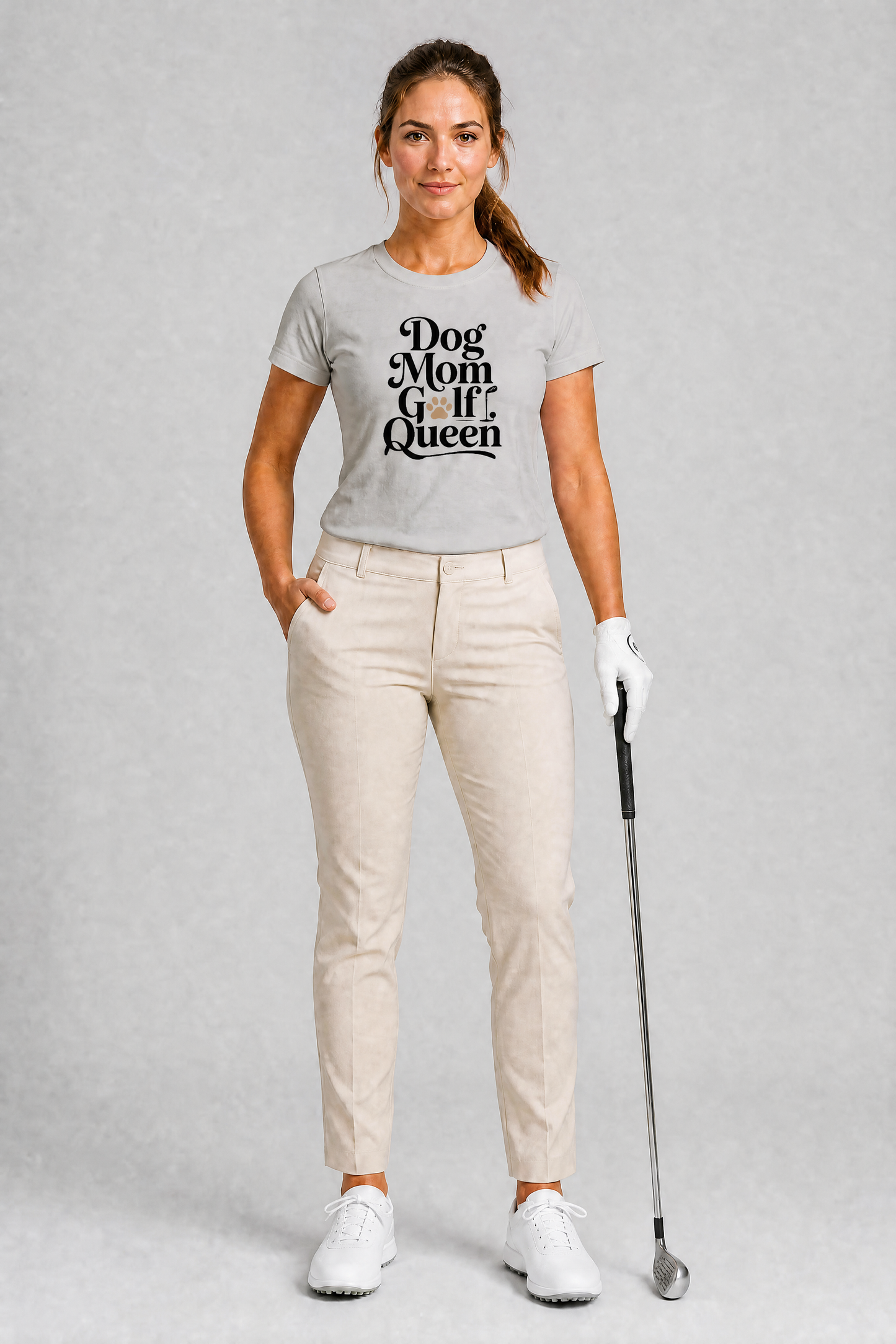 Woman wearing a gray t-shirt with 'Dog Mom Queen' text, holding a golf club on a gray background