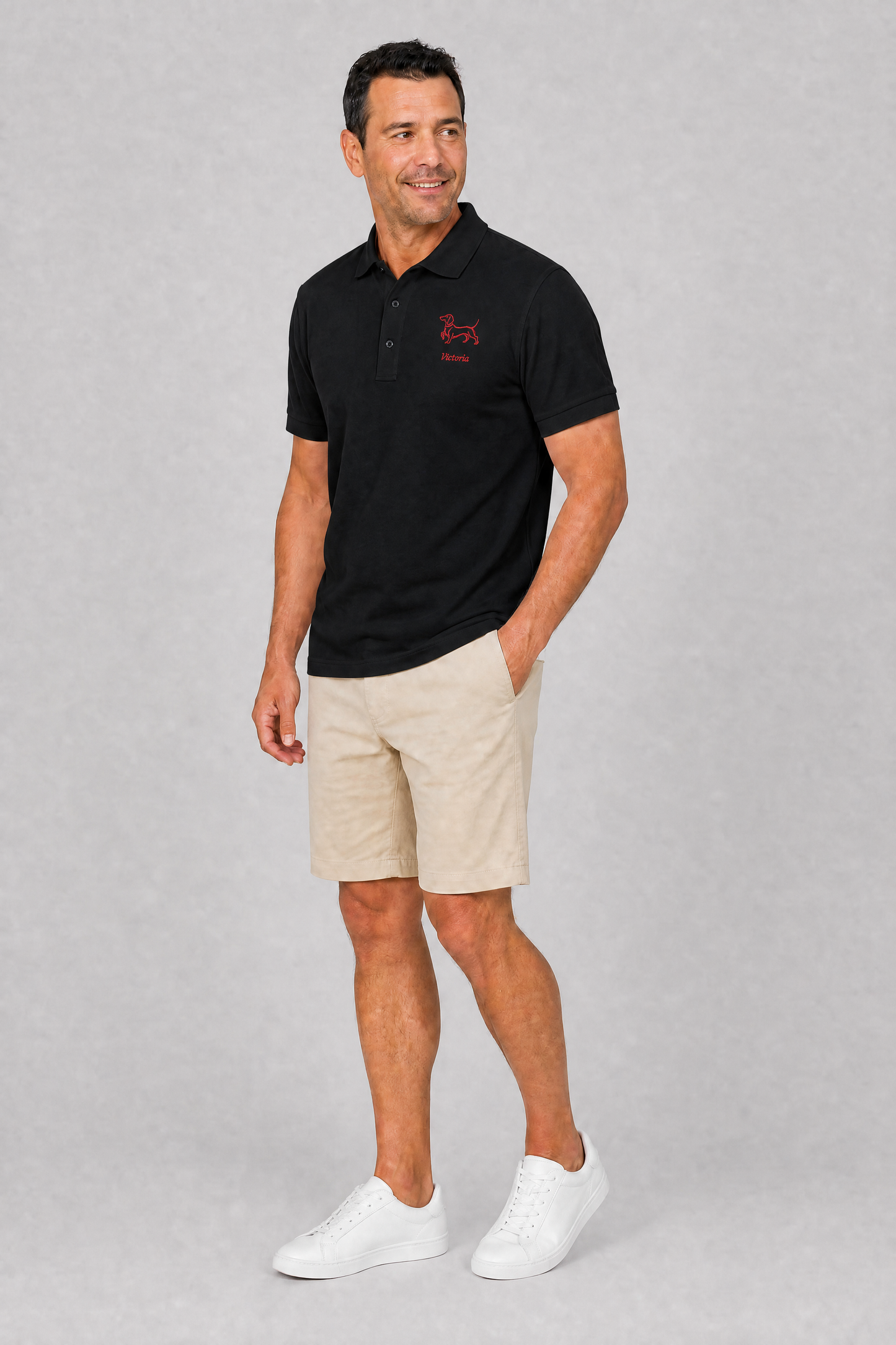 Navy embroidered dachshund polo shirt with personalized dog name, flat lay