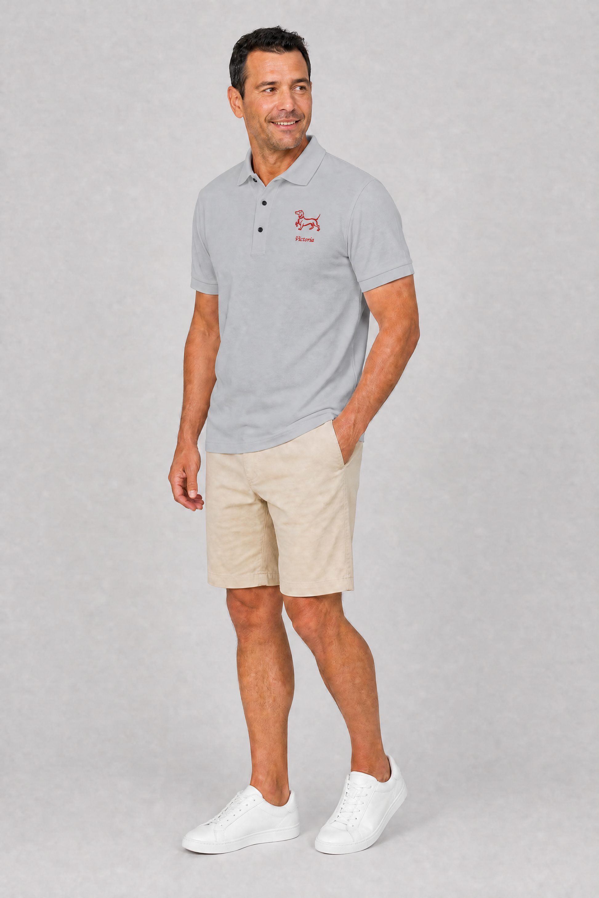 Steel grey embroidered dachshund polo shirt with personalized dog name, flat lay