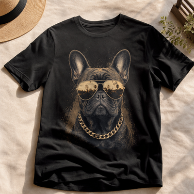 Black t-shirt with a graphic of a dog wearing sunglasses and a chain, placed on a textured surface.