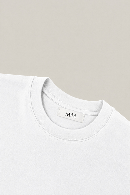 Ribbed crew neck of the white heavyweight cotton tee with the MVM woven neck label, close-up. Color: White