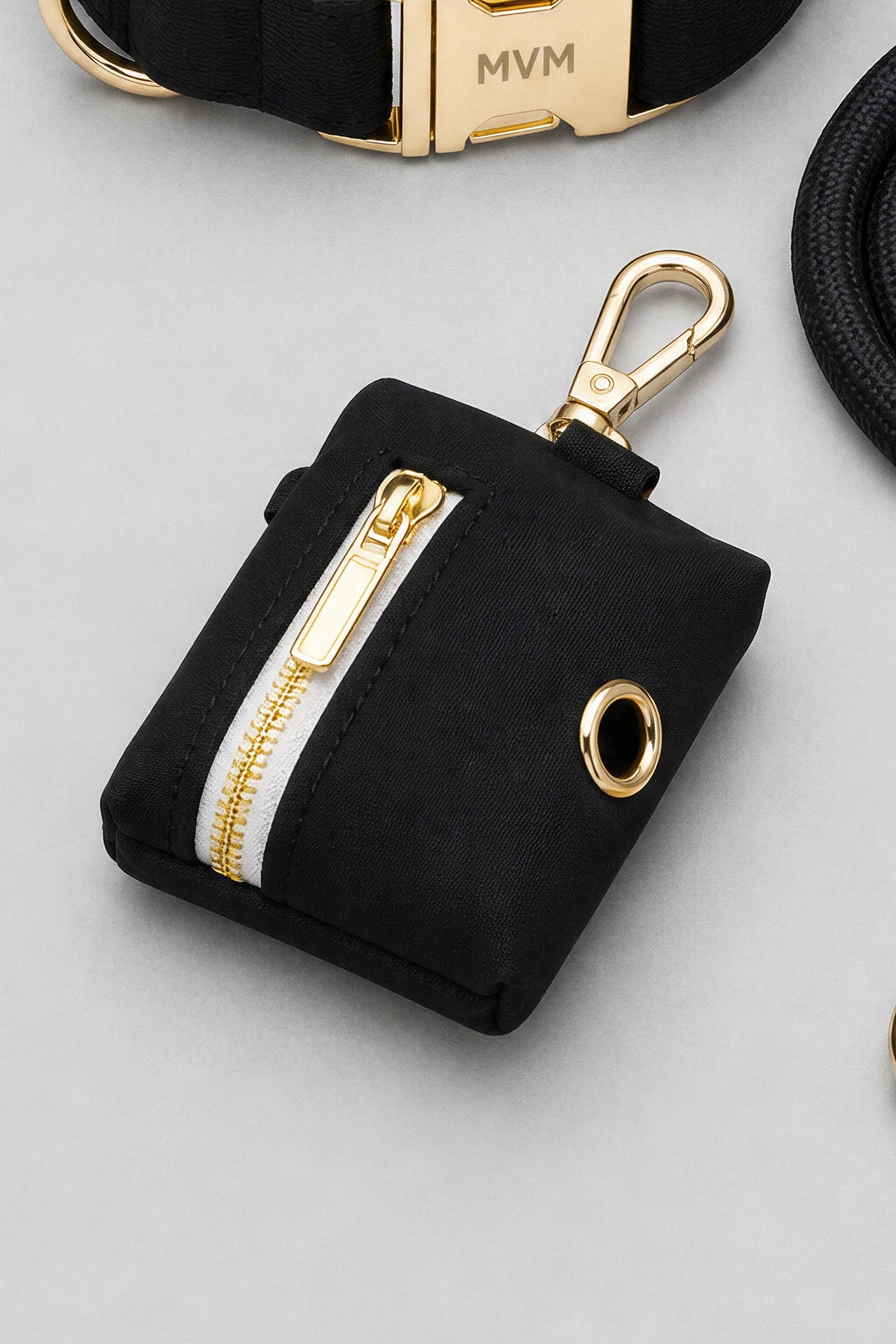 Black velvet poop bag holder with gold zipper from the MVM Evergreen set, detail