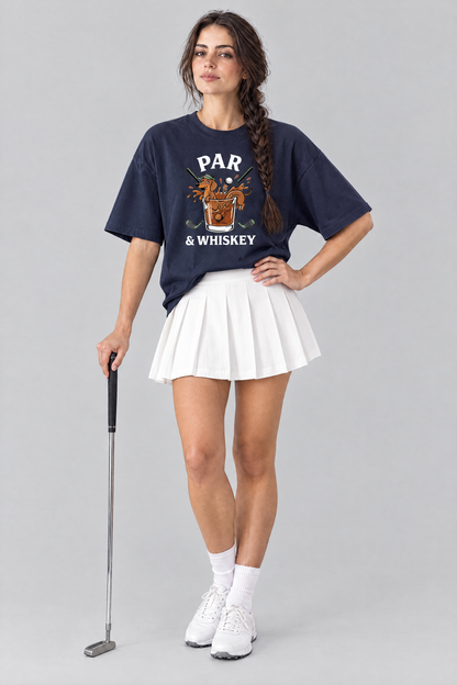 Woman wearing the Par & Whiskey Dachshund Golf Tee in navy with a white pleated skirt, holding a putter. Color: Navy