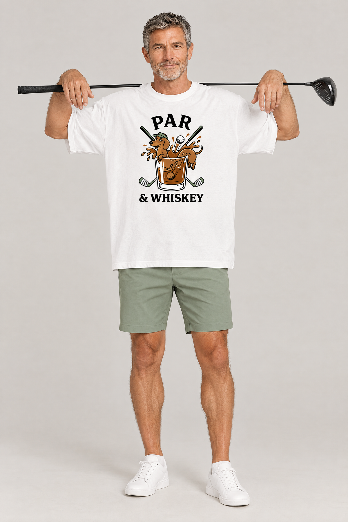 Man holding a driver behind his shoulders in the white Par & Whiskey Dachshund Golf Tee. Color: White