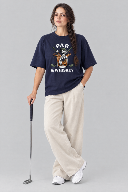 Woman holding a putter in the navy Par & Whiskey Dalmatian Golf Tee with stone wide-leg trousers. Color: Navy