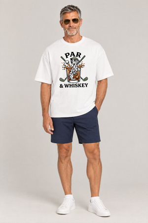 Man wearing the Par & Whiskey Dalmatian Golf Tee in white with navy golf shorts and aviator sunglasses. Color: White