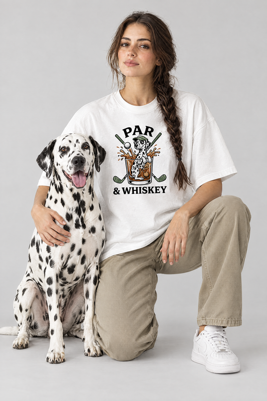Woman kneeling next to a Dalmatian dog in the white Par & Whiskey Dalmatian Golf Tee. Color: White