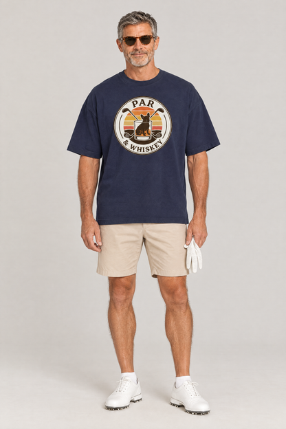 Man wearing the Par & Whiskey French Bulldog Badge Golf Tee in navy with beige golf shorts and sunglasses. Color: Navy